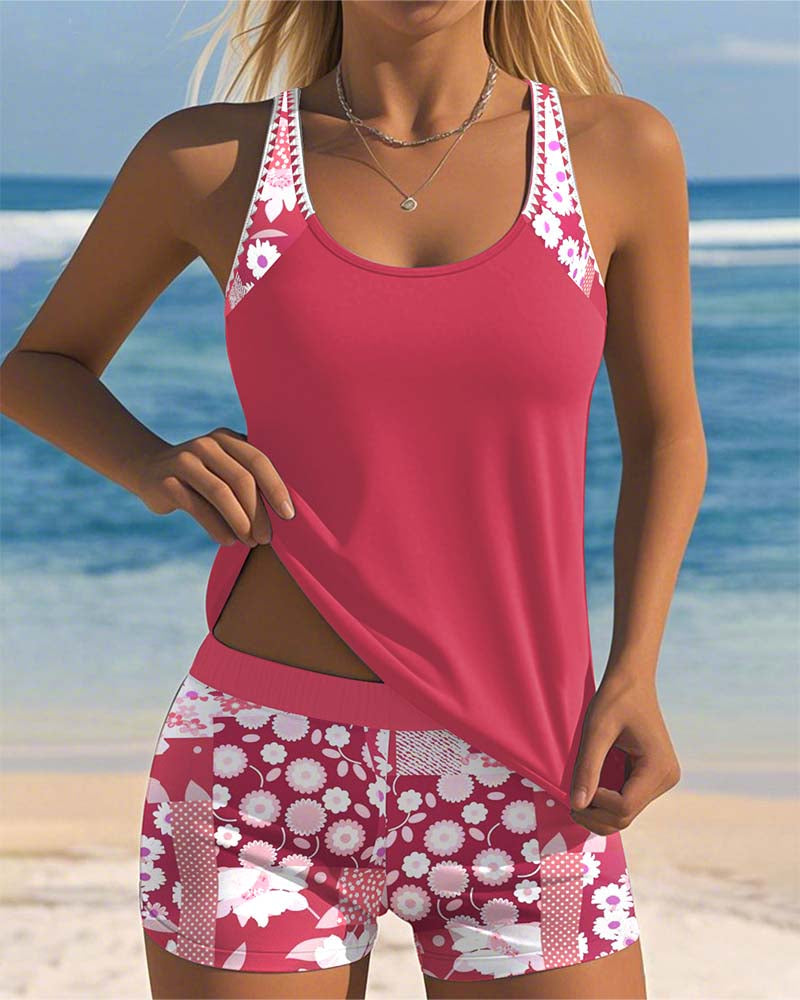 Woman wearing a floral tankini swimsuit with matching swim shorts on a beach background.