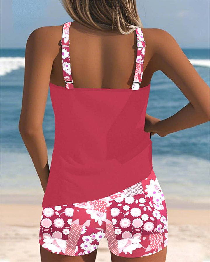 Female model in a two-piece floral swim set with tank top and shorts on a beach background.