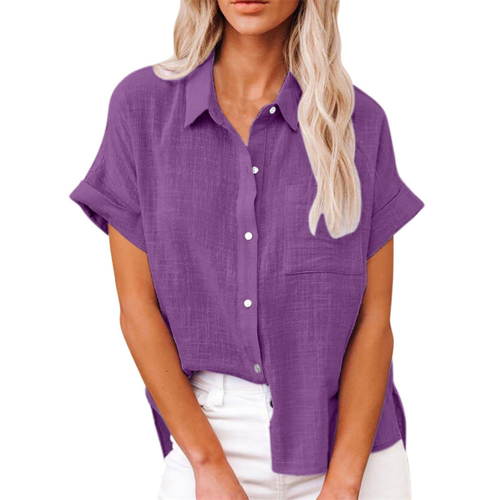  Woman wearing a long-sleeved striped blouse with a relaxed shape.