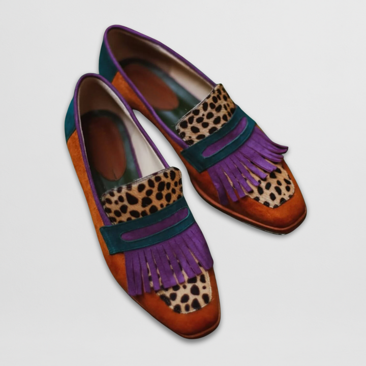 Polished loafers on a plain background.