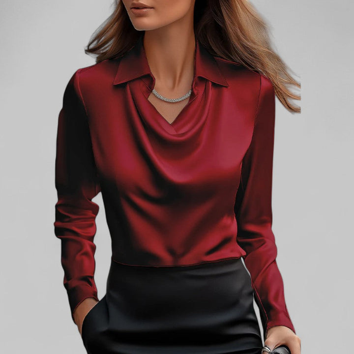  Female model in a long sleeve blouse with a smooth satin finish and elegant styling.