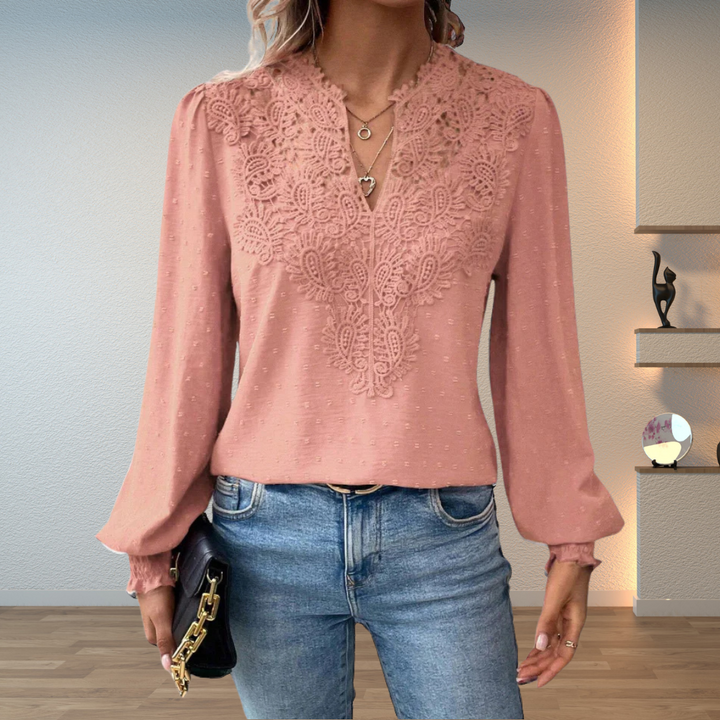  Female modelling a relaxed blouse with a flattering shape against a plain background.
