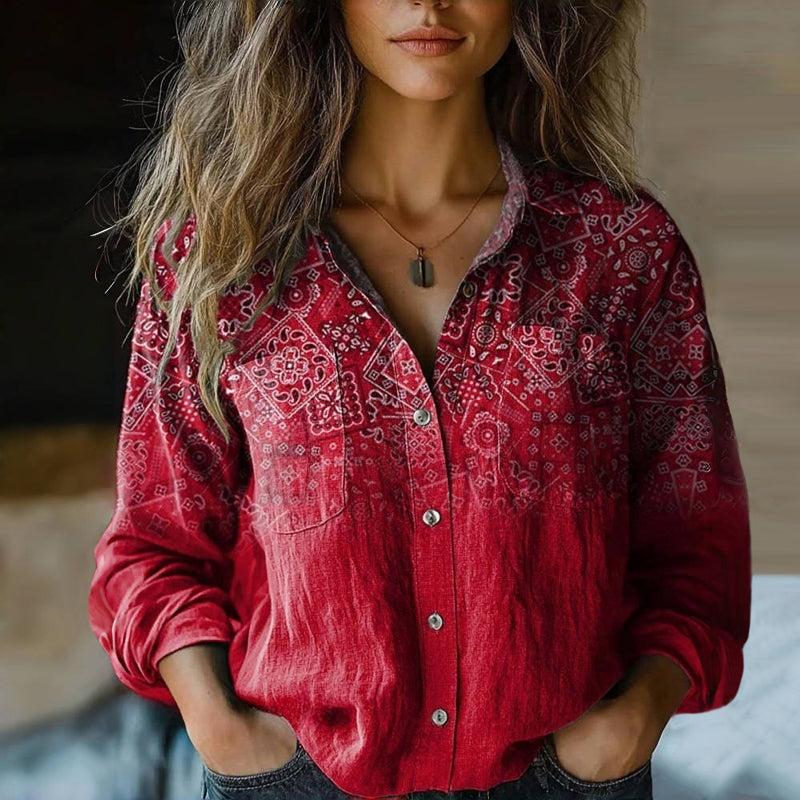Woman wearing a bohemian print blouse with a relaxed fit against a plain background.