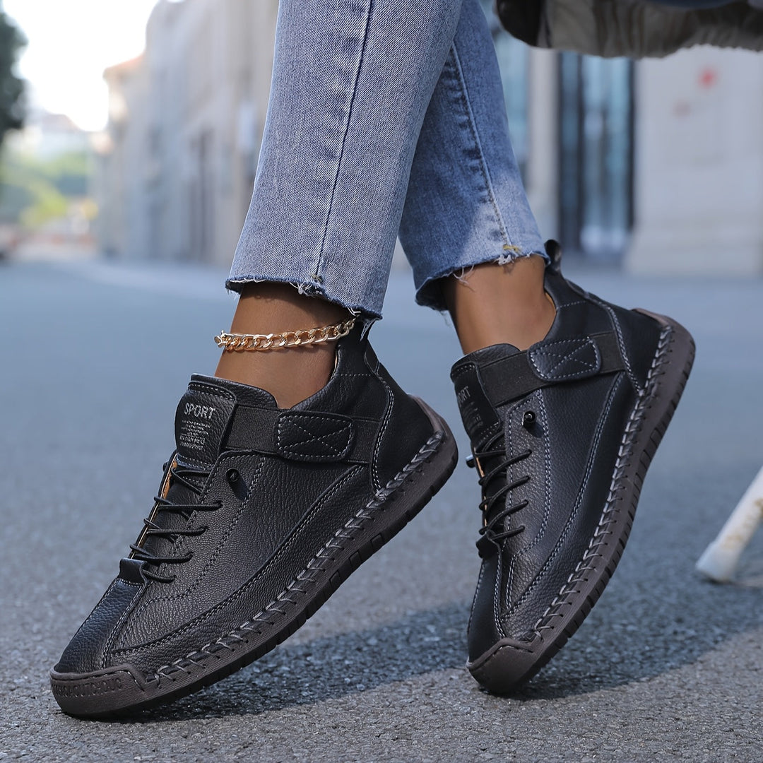  Female model wearing modern walking trainers with a cushioned sole on a plain background.
