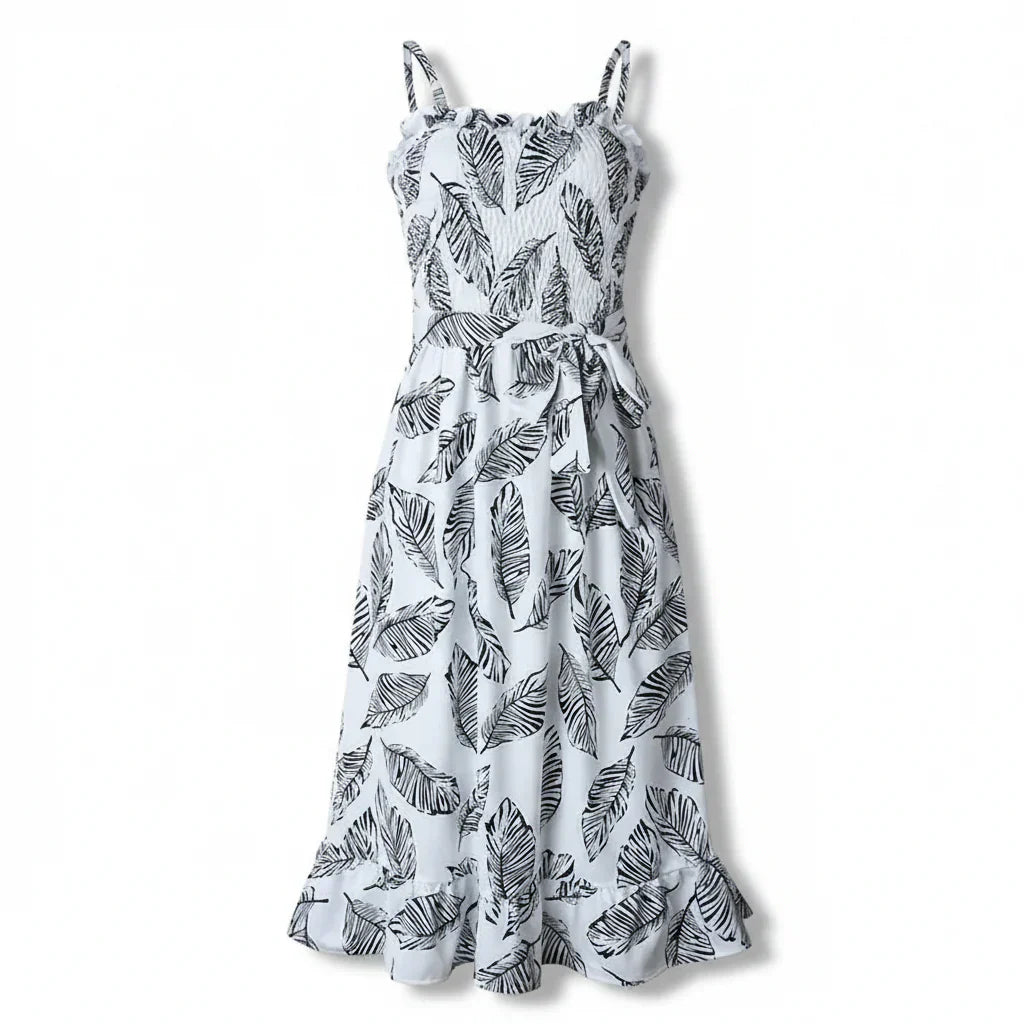  Woman in a sleeveless printed midi dress with a relaxed silhouette on a plain background.
