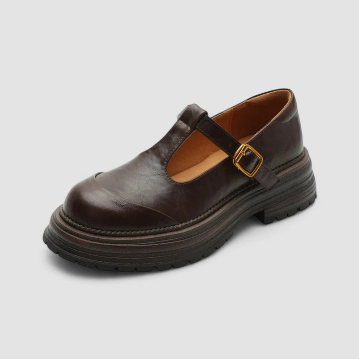 Closed-toe Mary Jane shoes against a plain background.