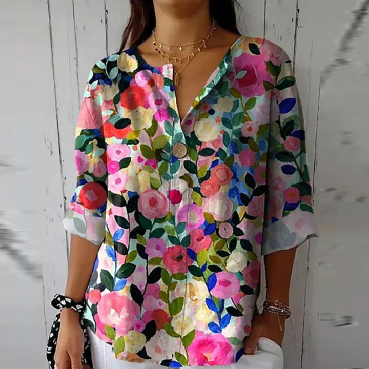  Female in a lightweight blouse featuring an all-over floral print.