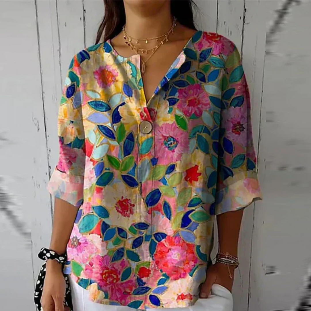  Woman modelling an elegant floral top with everyday styling appeal.