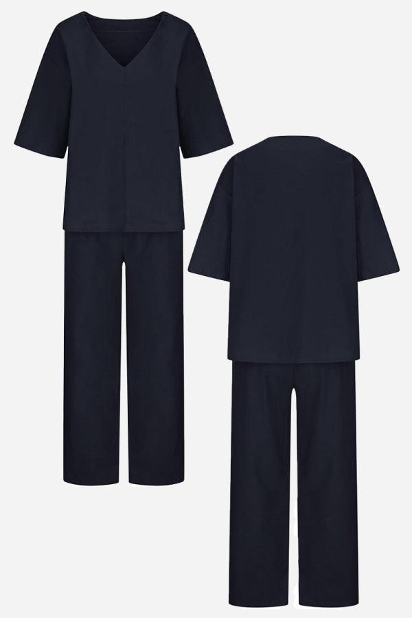 Female model wearing a coordinated set with mid-length sleeves and straight-leg trousers.