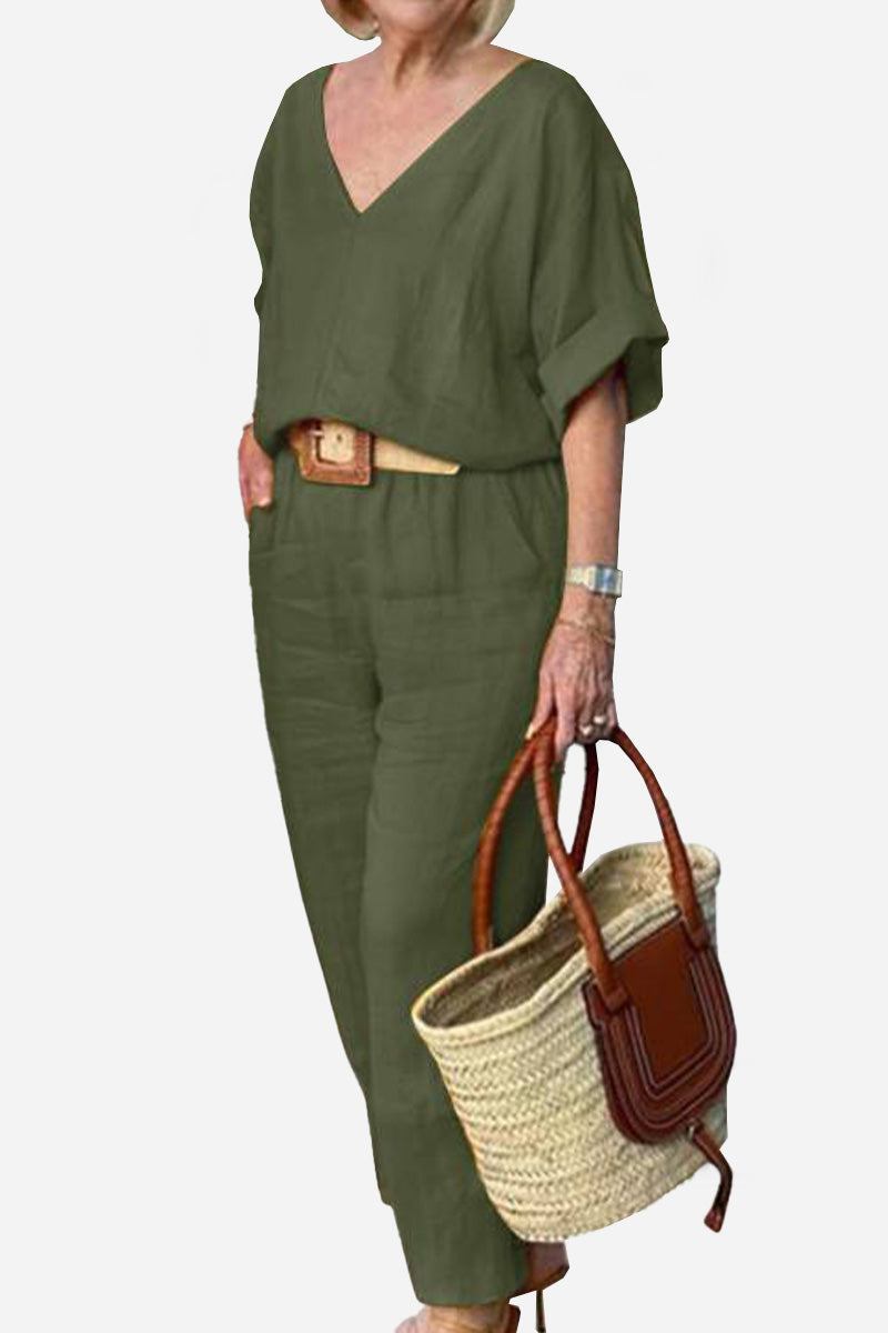  Woman wearing a solid-colour two-piece set with a V-neckline and relaxed fit on a plain background.
