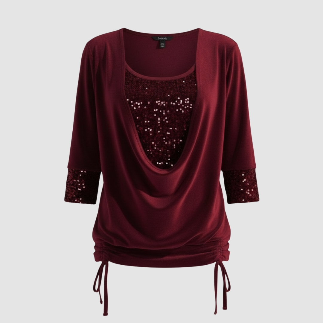 Loose-fit shimmering blouse on a plain background.