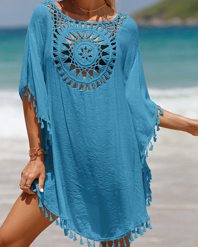 Female model wearing a lightweight crochet cover up styled over swimwear on a plain background.