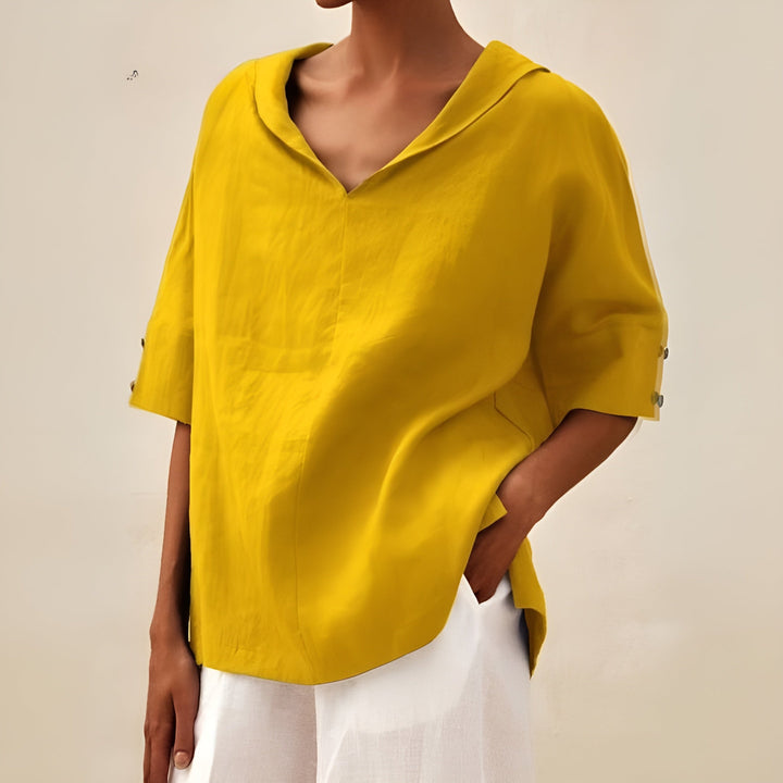 Woman in a lightweight blouse styled for relaxed daily wear.