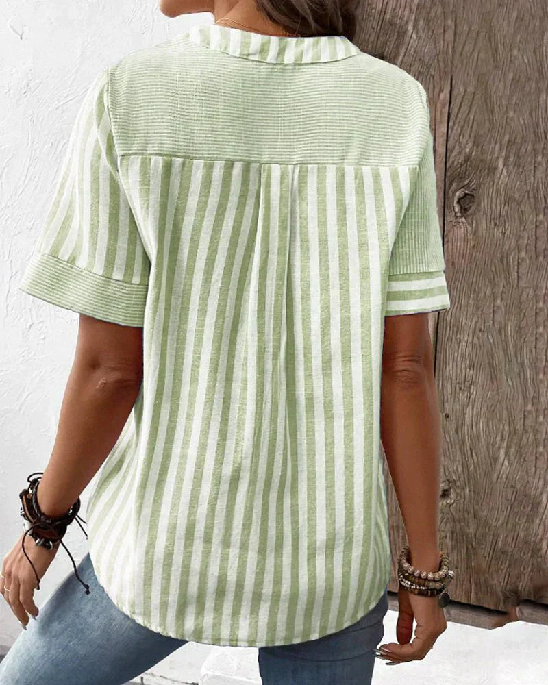  Woman modelling a classic striped blouse with a loose draped shape