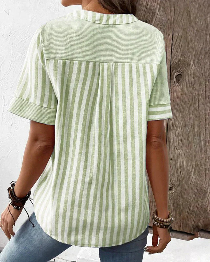  Woman modelling a classic striped blouse with a loose draped shape