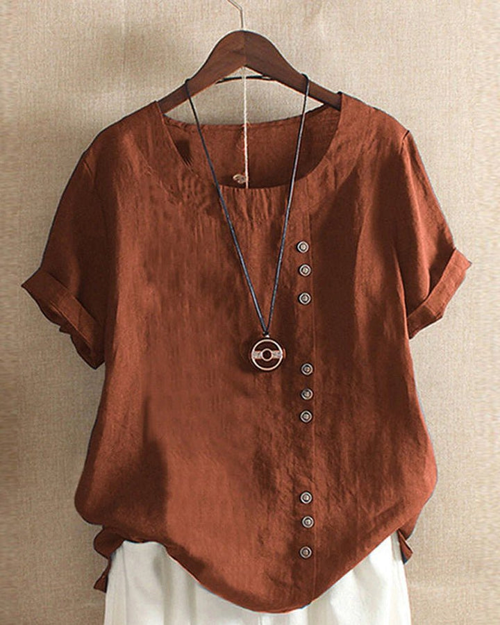  Woman in a relaxed fit short sleeve top with a curved hem.