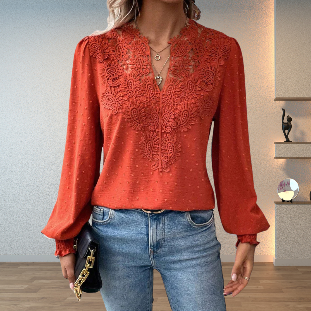 Woman wearing a lightweight blouse with a flattering silhouette against a plain background.