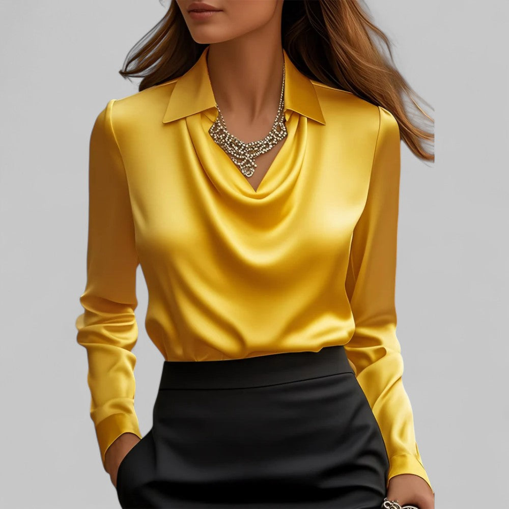  Woman showcasing an elegant long sleeve blouse with a softly draped front on a plain background.