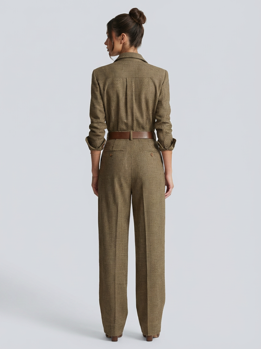 Woman in a tailored check jumpsuit with wide-leg styling on a plain background.