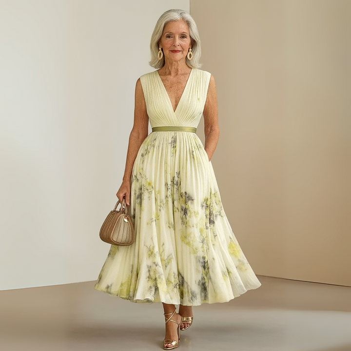 Woman modelling a sleeveless V-neck dress with an ankle-length silhouette.