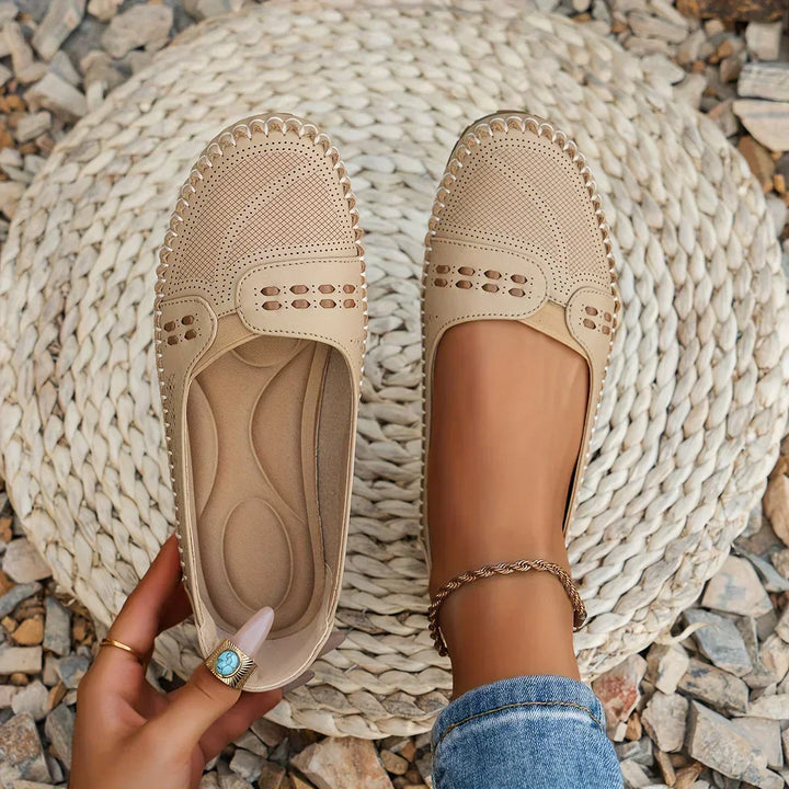 Woman wearing stylish flats on a nature background.