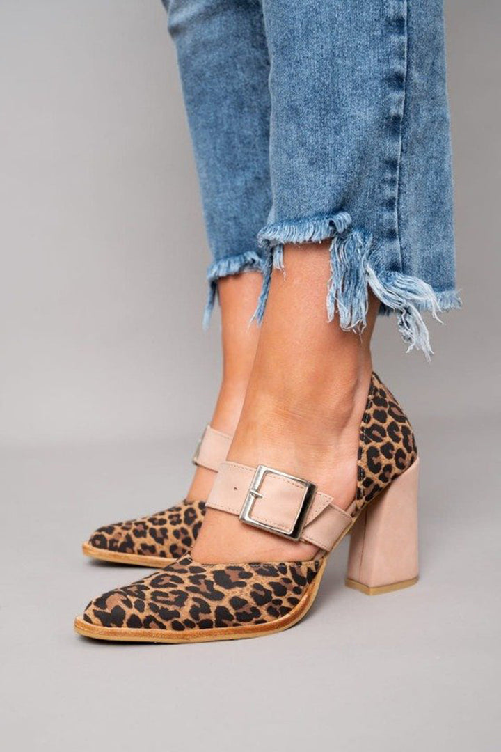 Leopard pattern dress sandals with slim straps on a plain background.