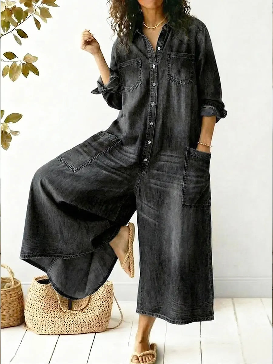Woman styled in a casual denim jumpsuit with chest pockets on a plain background.