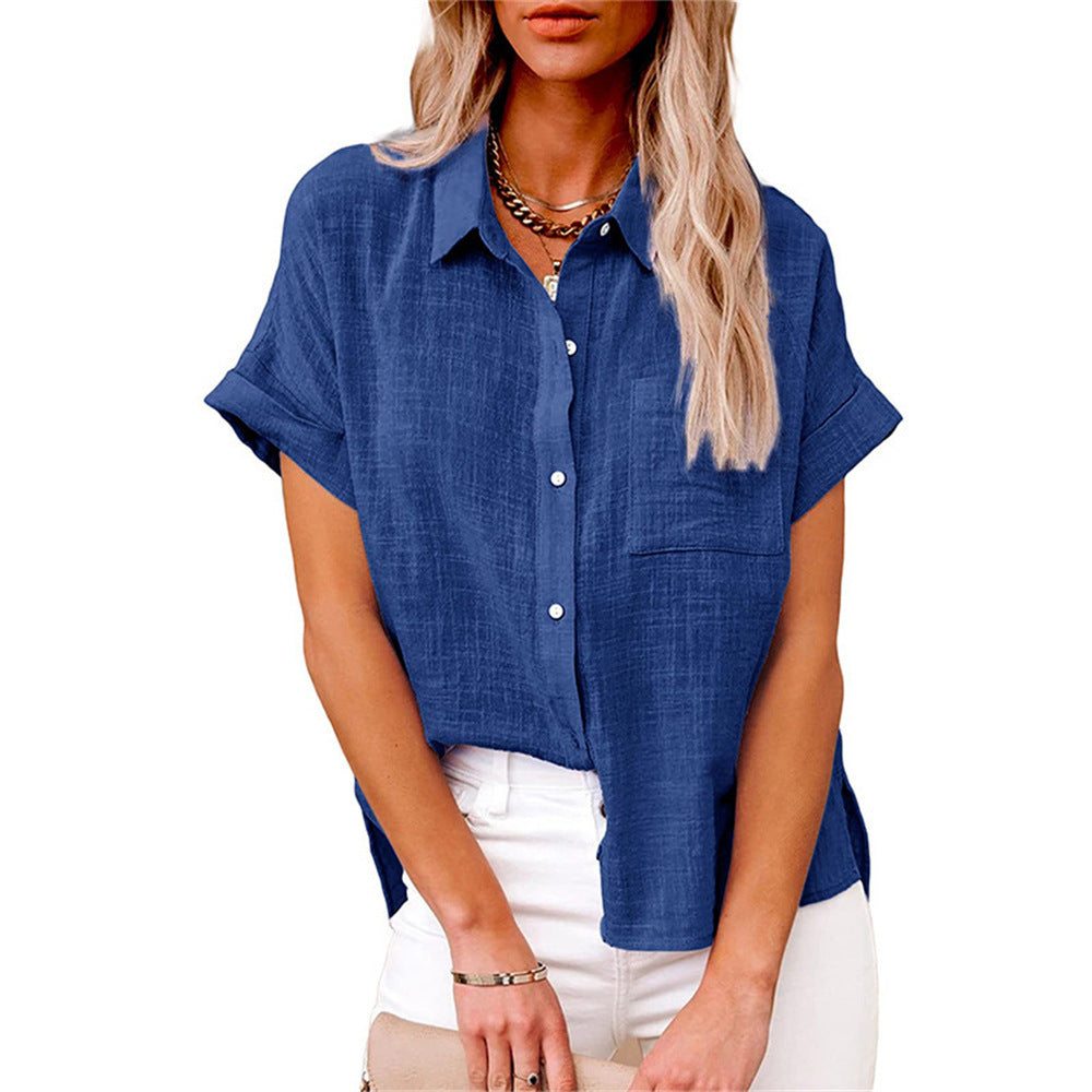 Female wearing a striped blouse with a loose silhouette against a plain background.