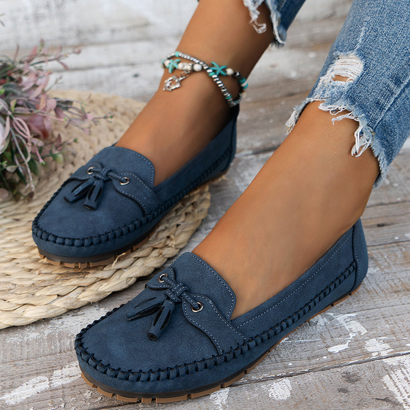 Women’s vintage loafers with bow detail shown on a plain background.