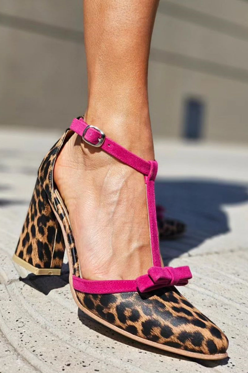 Female model wearing leopard print stiletto sandals on a plain background.