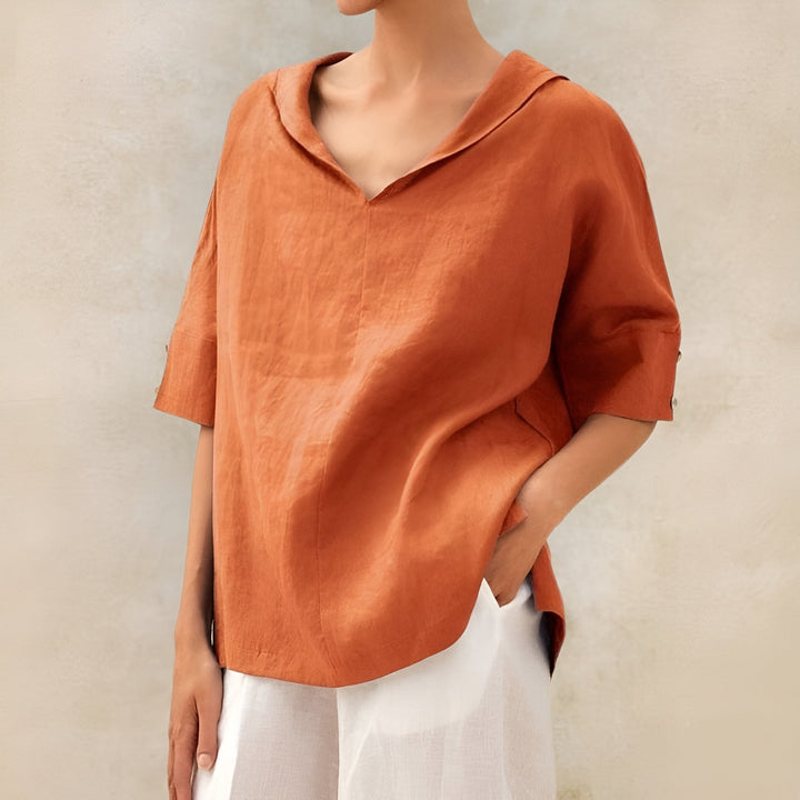  Woman wearing a versatile blouse against a plain background.