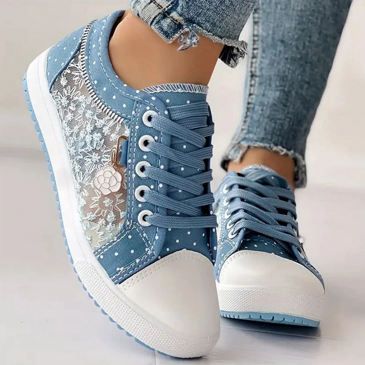  Female wearing low-top trainers designed for casual daily styling on a plain background.