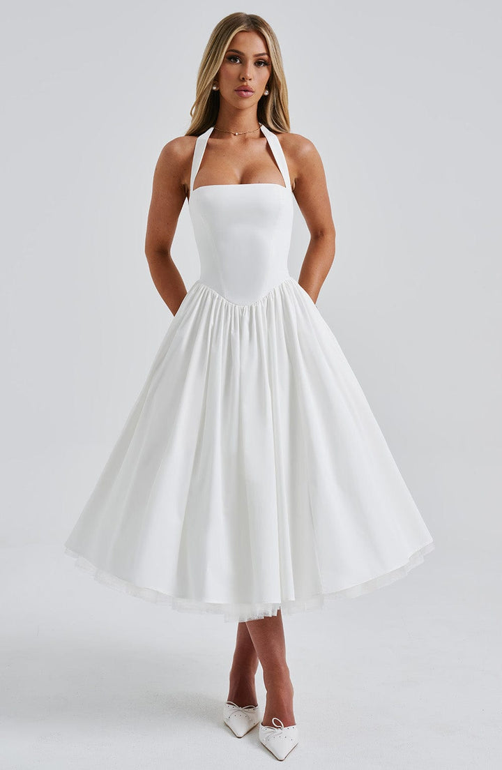 Model wearing a fitted bodice midi dress with a flowing skirt on a plain background.