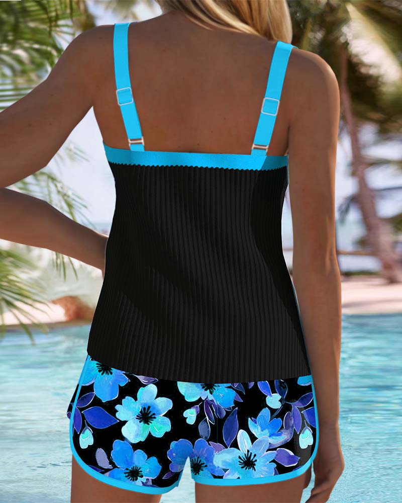 Woman posing in a supportive two-piece swim outfit with sleek shaping detail on a plain background.