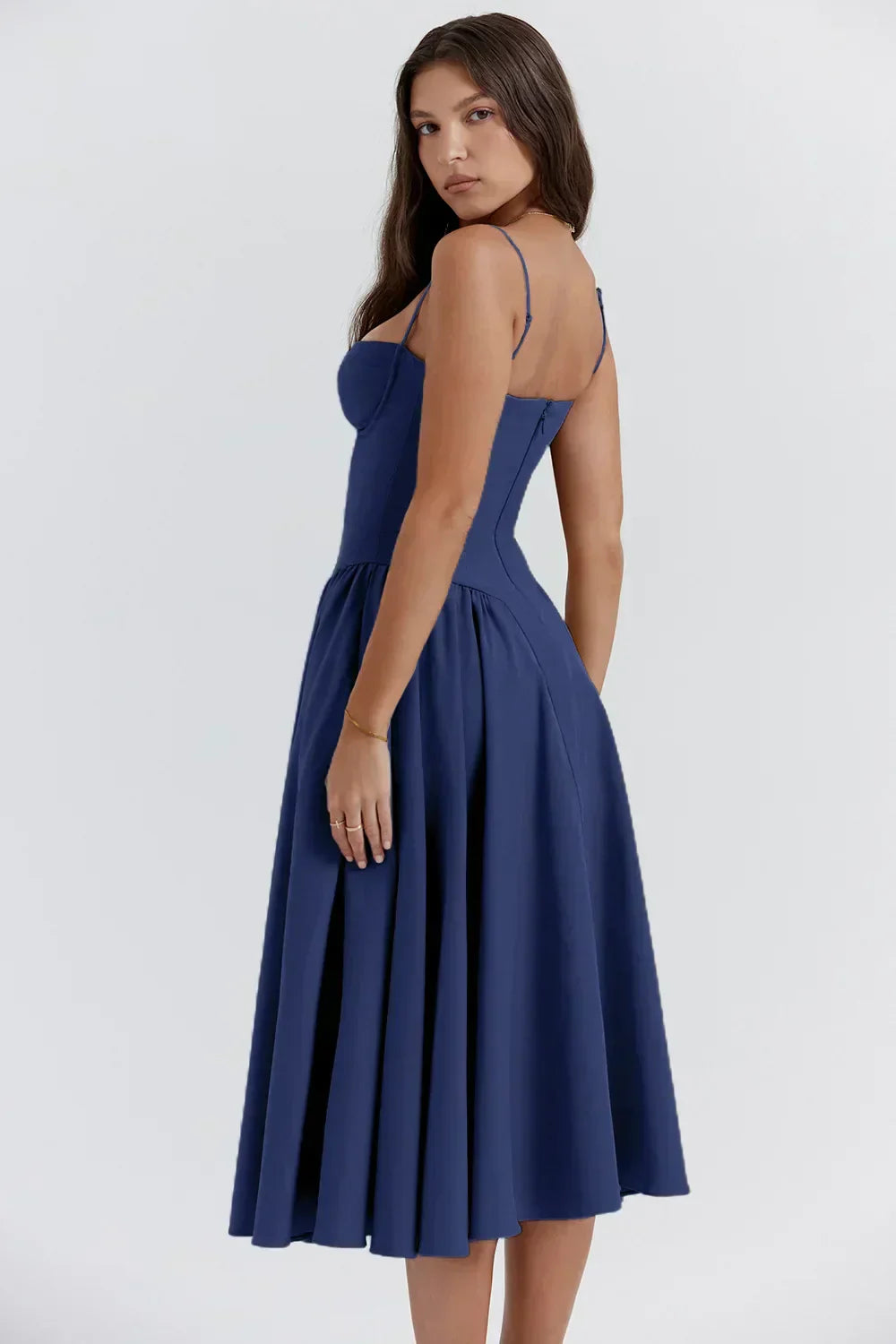 Model wearing a sleeveless midi dress with a soft flowing skirt on a plain background.