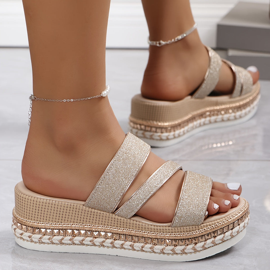 Woman in casual open-toe sandals with glitter accents and cushioned sole.