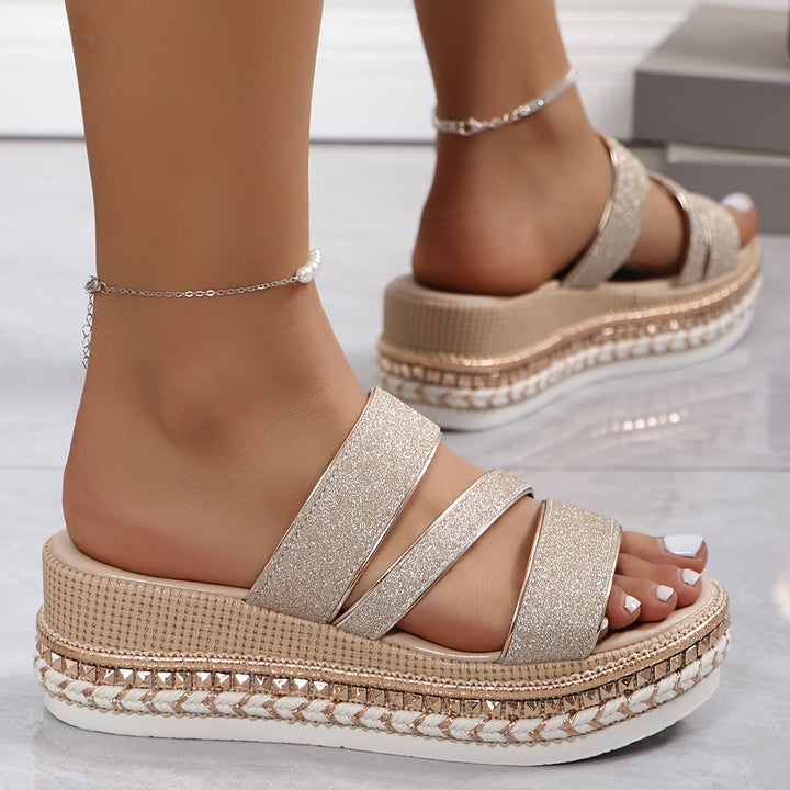 Woman in casual open-toe sandals with glitter accents and cushioned sole.
