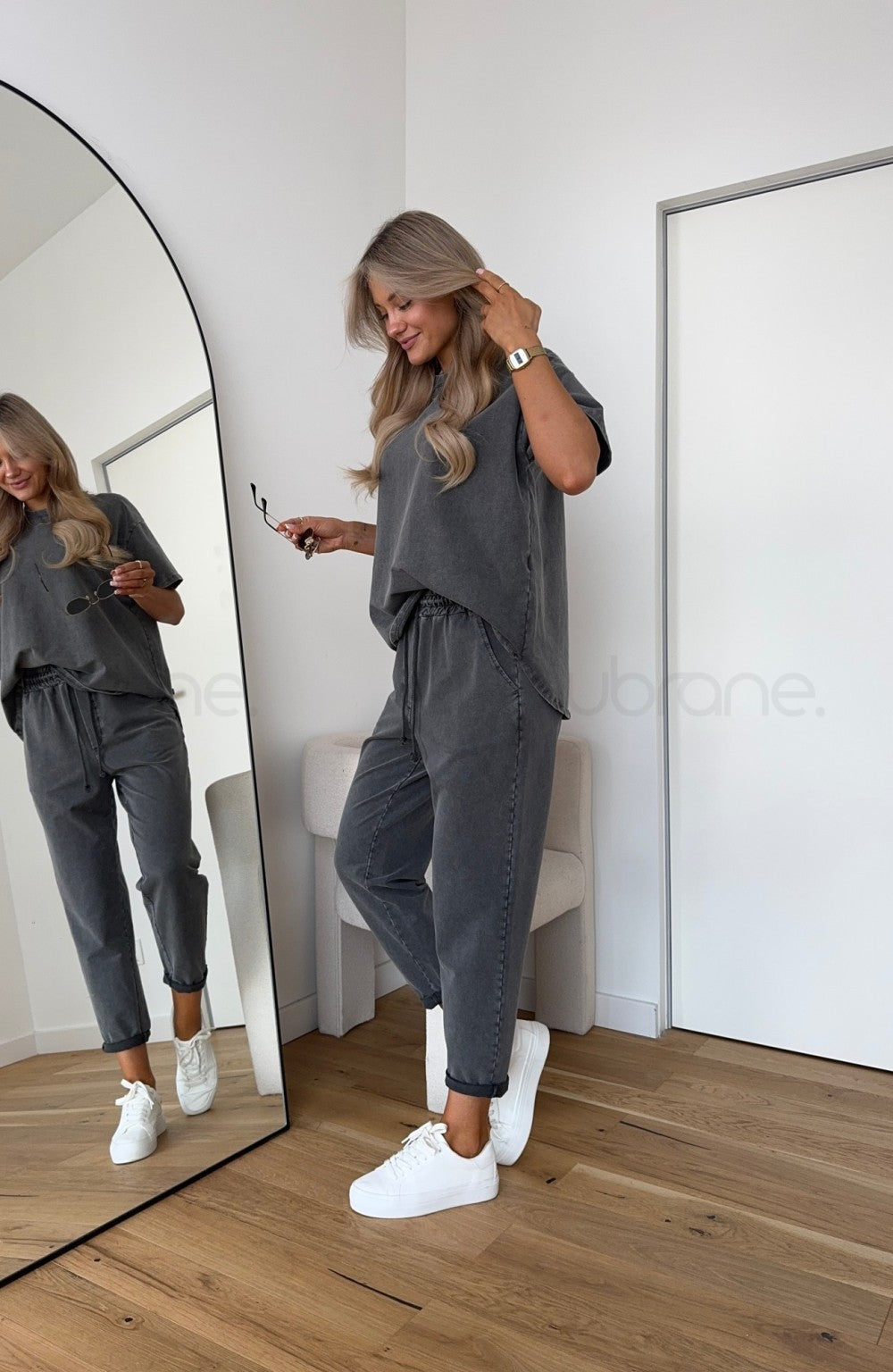 Woman in a matching striped co-ord set featuring relaxed-fit separates on a plain background.