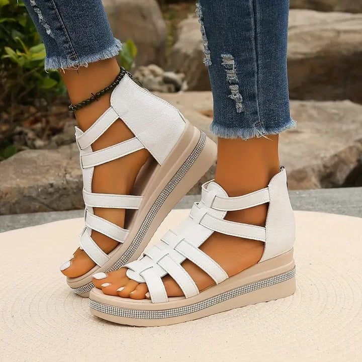 Woman displaying lightweight sandals with adjustable fastening and elegant accents.