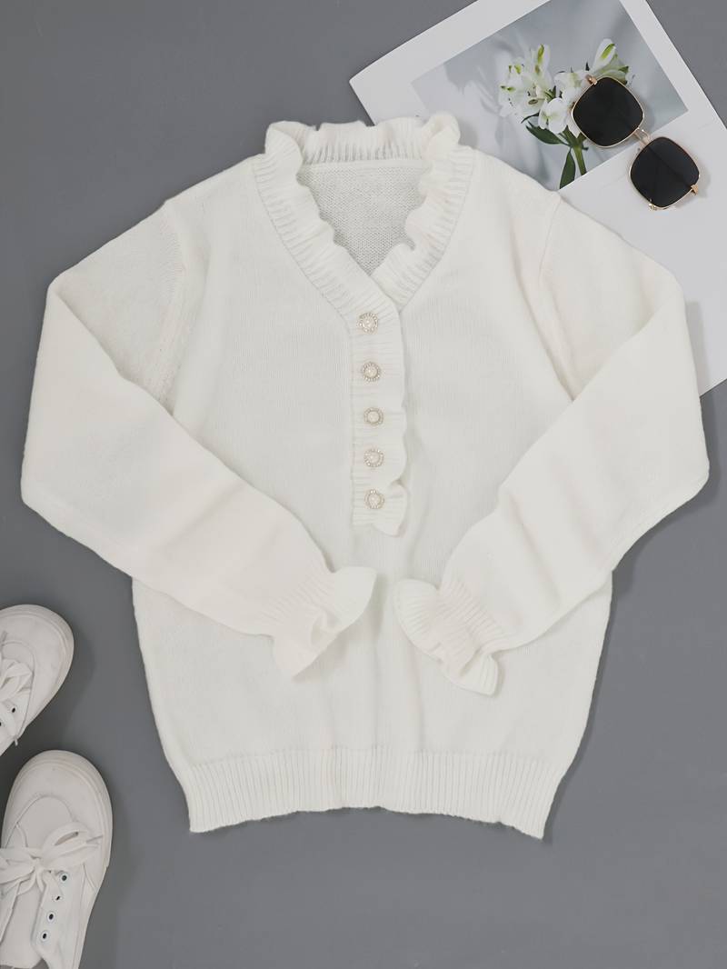 Elegant ruffle neckline blouse on a plain background.