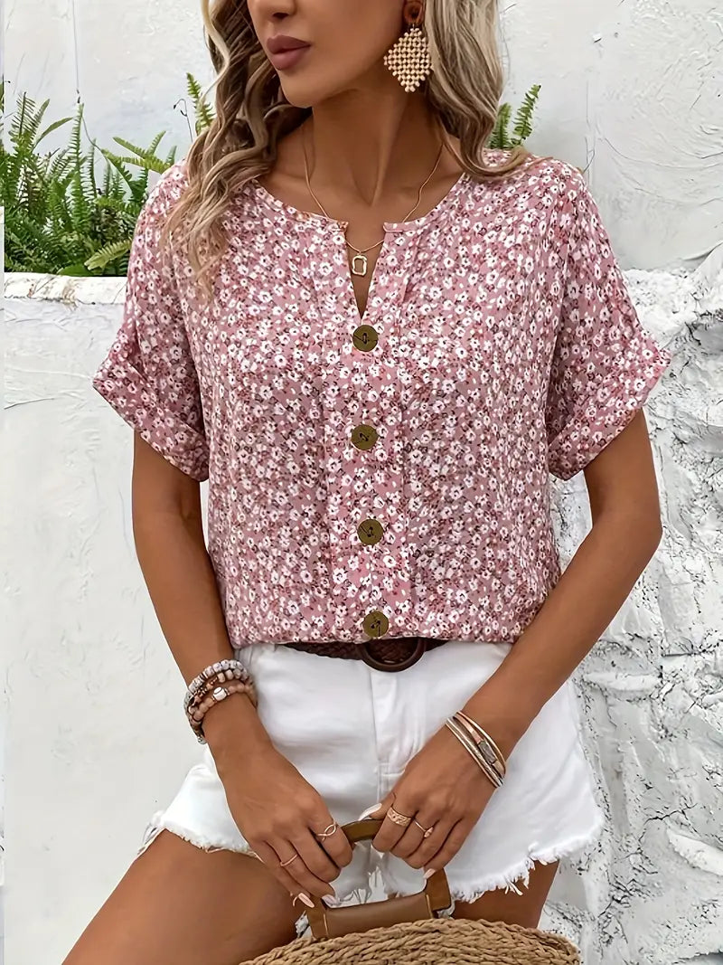  Female model showcasing a floral button-up blouse with a loose and airy shape.