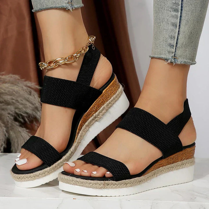 Woman displaying lightweight casual sandals on a plain background for day-to-day wear.