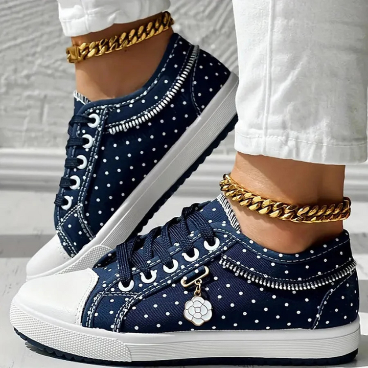  Woman showcasing lace-up footwear with a streamlined design on a plain background.