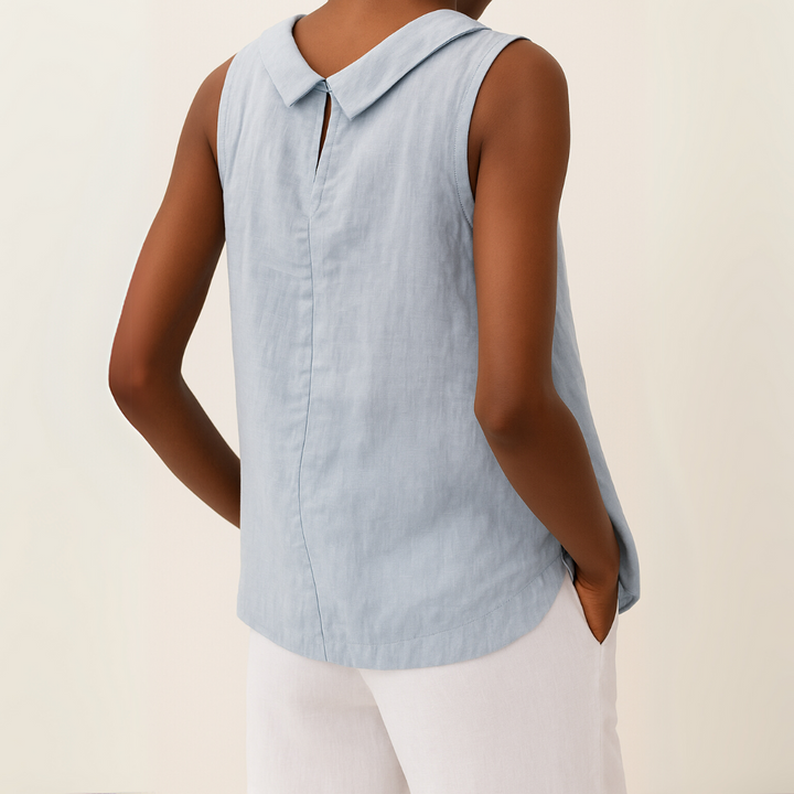  Woman wearing a sleeveless top styled for warm-weather outings against a plain backdrop.
