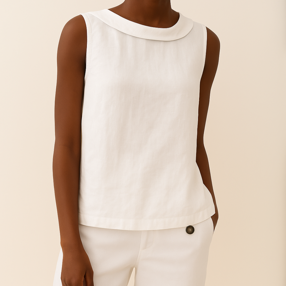 Woman in a sleeveless top with a clean and elegant silhouette on a plain background.