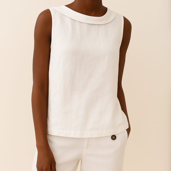 Woman in a sleeveless top with a clean and elegant silhouette on a plain background.