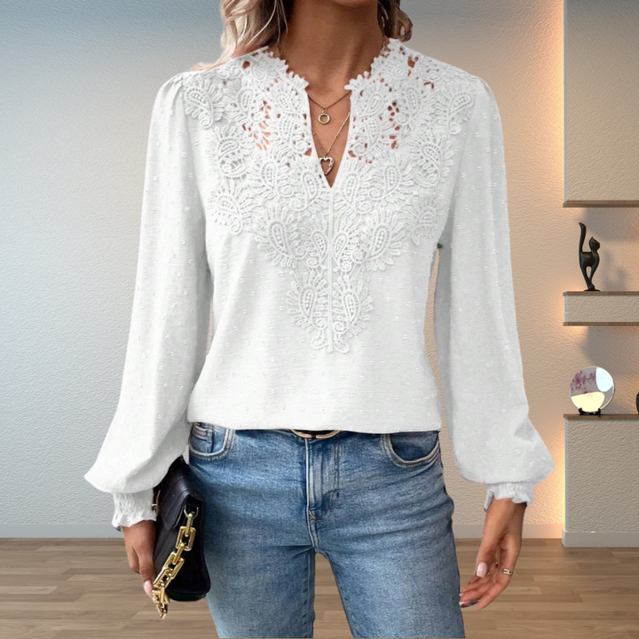  Woman in a stylish long-sleeve blouse on a plain background.