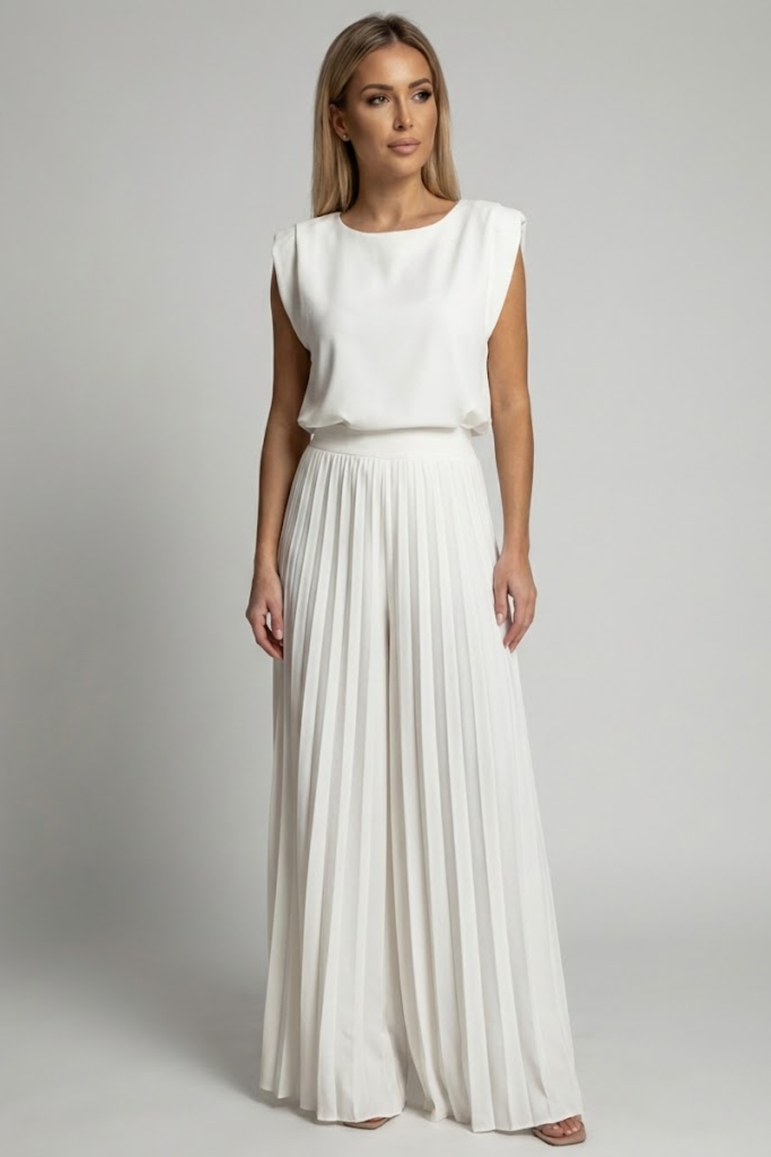 
Female model in a flowing two-piece outfit designed for warm-weather styling.