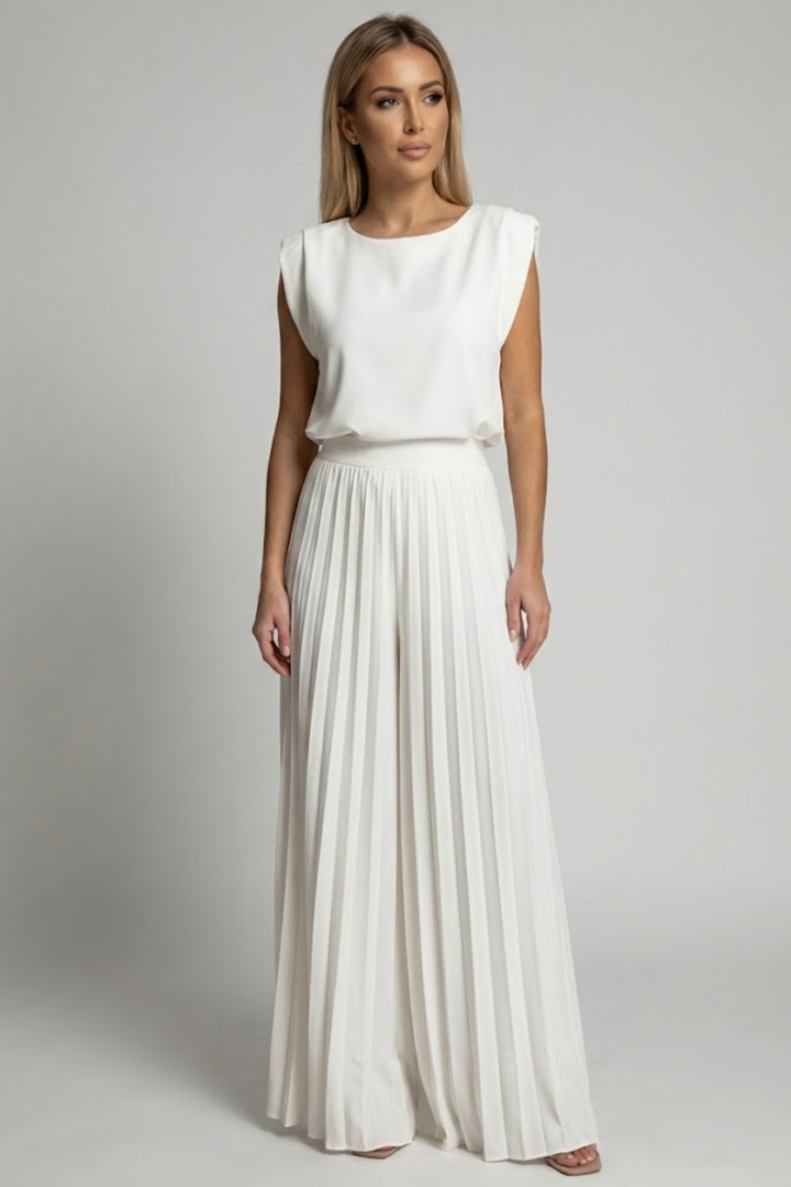 
Female model in a flowing two-piece outfit designed for warm-weather styling.