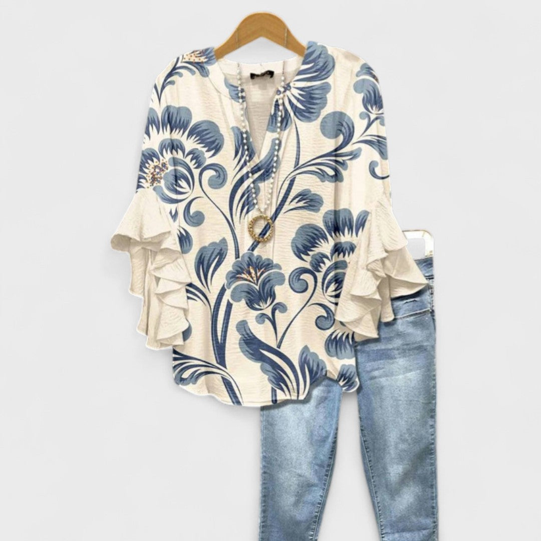 Feminine everyday blouse against a plain background.